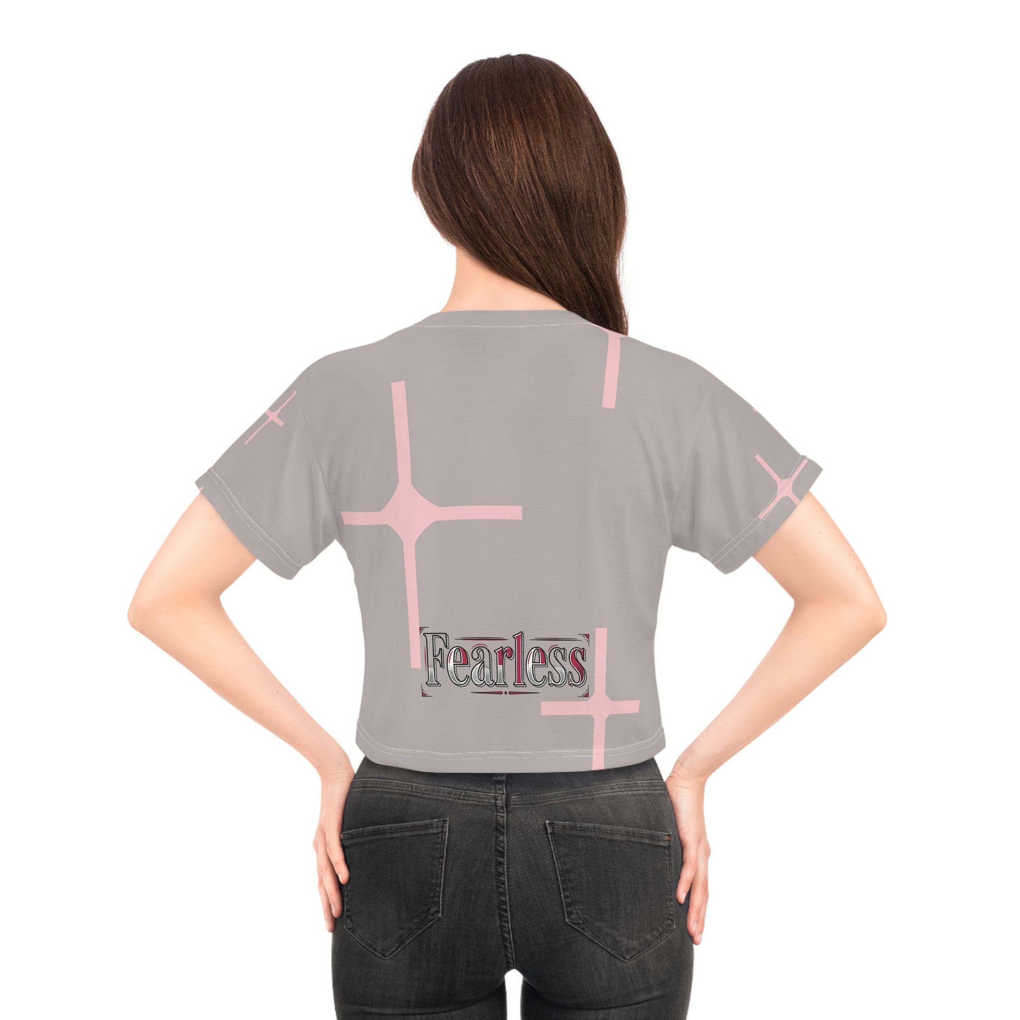 Back view of a woman wearing a pink cross graphic crop tee for women, featuring the word &